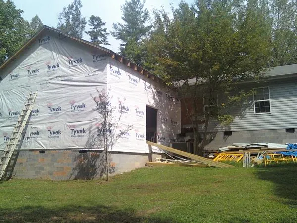 Tyvek wrapped gable on a new room addition beside an existing home in Northampton